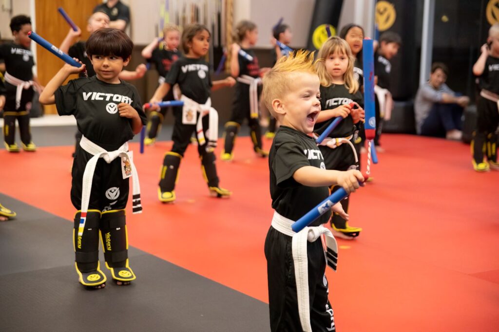 An Exited Boy Practicing With Nunchucks at Victory Martial Arts in Williamston