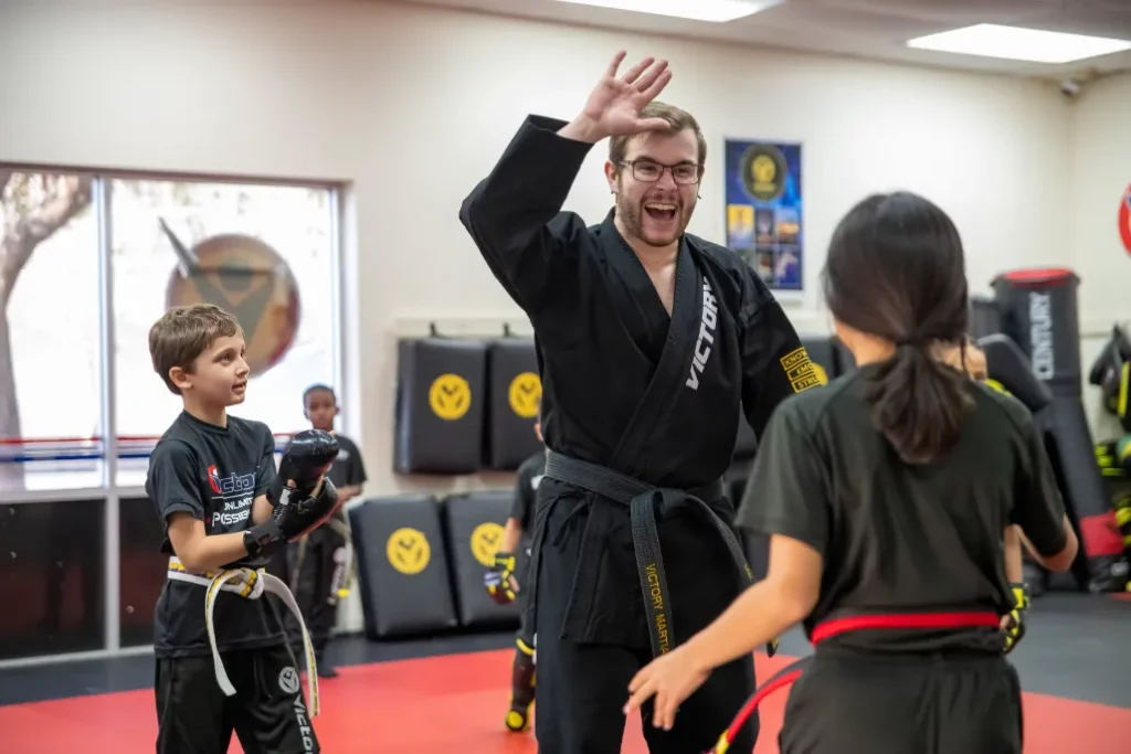 Karate Instructor High Fiving Students at Karate Drills for Kids in Oviedo, Florida